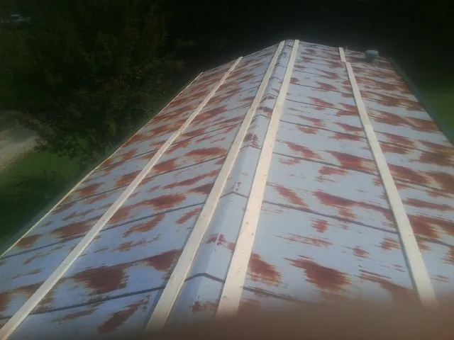 Rusted metal roof panels with new wood purlins before replacement — Storm Damage Roof Repair in Pineland by Roofing Brothers